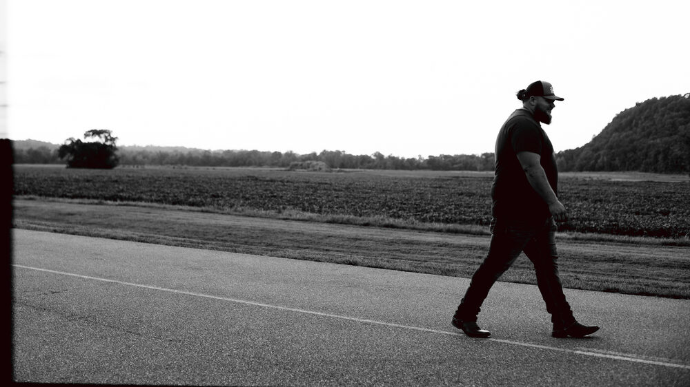 Hank Singleton walking a country road